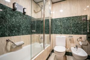 a bathroom with a toilet and a shower and a sink at Abba Rambla Hotel in Barcelona