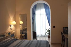 Кровать или кровати в номере Hotel Falcone