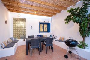 a patio with a table and chairs and a grill at Villa Irini in Kallithea Rhodes