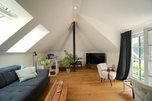 a living room with a blue couch and a table at Ferienwohnung "Wasserburg" in Ascheffel