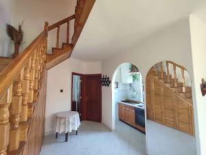 a hallway with a staircase and a kitchen with a table at Holiday home in Balatonkeresztur 44886 in Balatonkeresztúr