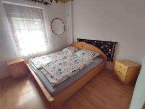 a small bedroom with a bed and a window at Holiday home in Balatonkeresztur 44886 in Balatonkeresztúr