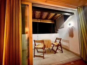 a room with two chairs and a table on a balcony at Edita Apartments in Tivat