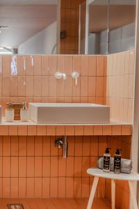 a bathroom with a sink on a tiled wall at Leisure Escape with a sea view by Salt Apartments in Volos