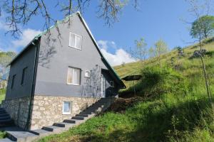 a house on top of a grassy hill at 4NORTH Apartment17 in Plužine