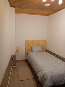 a bedroom with a bed in the corner of a room at A Riquiña in Mondariz +12 photos