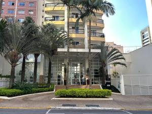 a building with palm trees in front of it at SH130 Abrace a Simplicidade na Rua Bela Cintra in Sao Paulo