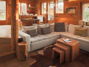 a living room with a couch and a table at Apartment Praz 11 by Interhome in Verbier +21 photos