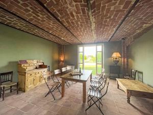 a room with a brick ceiling with a table and chairs at Holiday Home Villa Remotti by Interhome in Fubine