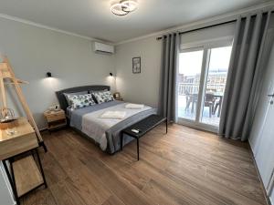 a bedroom with a bed and a sliding glass door at Vista Kavala Center in Kavála
