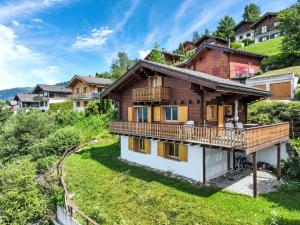 a house on a hill with a balcony at Chalet Chalet Boucaro by Interhome in Nendaz