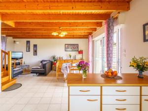 a kitchen and living room with wooden ceilings at Holiday Home Stereden Vor by Interhome in Primelin +26 photos
