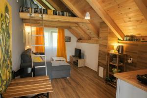 a small living room with a couch and a tv at 4NORTH Apartment17 in Plužine
