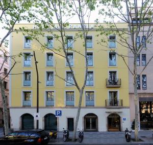 a yellow building with motorcycles parked in front of it at Abba Rambla Hotel in Barcelona