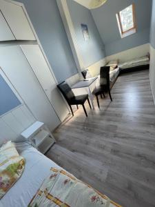 a room with two beds and a table and chairs at Dom Gościnny Tomasz Mielenko in Mielenko +10 photos