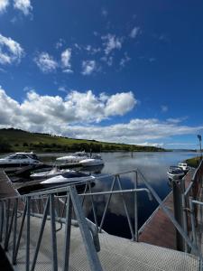 a group of boats docked at a dock on a lake at The Cranagh in Coleraine