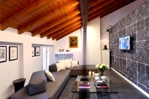 a living room with a couch and a table at Phi Hotel Bologna in Bologna