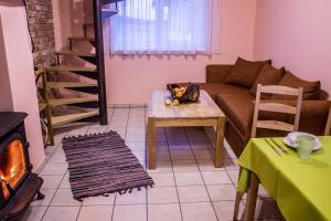 a living room with a couch and a table at Holiday Home Četri Vēji in Turkalne