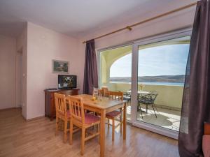 a dining room with a table and chairs and a balcony at Apartment Vlasta-1 by Interhome in Jadranovo +52 photos