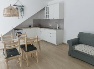 a kitchen and a living room with a table and chairs at Apartma Edra - Žusterna in Koper +8 photos