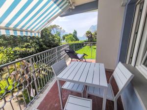 a patio with a table and chairs on a balcony at Apartment Garda Sapphire by Interhome in Riva del Garda