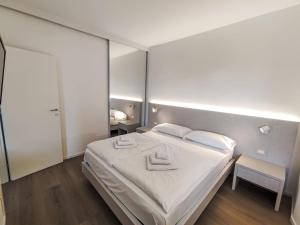 a bedroom with a bed with two towels on it at Apartment Garda Sapphire by Interhome in Riva del Garda