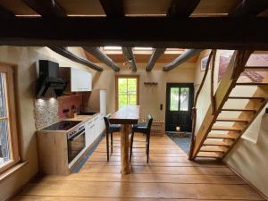a kitchen with a table and a staircase in a house at Ferienhaus Romantica in Bruttig-Fankel für 2 Personen in Bruttig-Fankel +22 photos