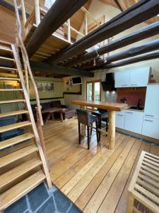 a kitchen and dining room with a wooden floor at Ferienhaus Romantica in Bruttig-Fankel für 2 Personen in Bruttig-Fankel