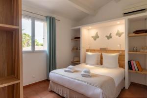 a bedroom with a bed with towels on it at Les Maisons Du Sud in Saint-Tropez +37 photos
