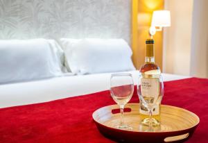 a bottle of wine on a tray with two glasses at Abba Rambla Hotel in Barcelona