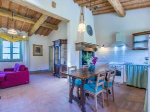 a kitchen and living room with a wooden table and chairs at Apartment Cotto by Interhome in Castiglioncello