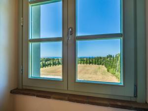 a window with a view of a field at Apartment Cotto by Interhome in Castiglioncello