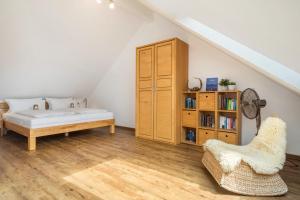 a bedroom with a bed and a book shelf at Time Out - Appartement Bodensee in Friedrichshafen