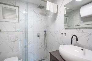 a white bathroom with a shower and a sink at Apartments dida Ante in Blato +38 photos