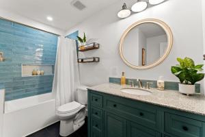 a bathroom with a sink and a toilet and a mirror at Lakefront Living w/Optional Boat Rental in Mooresville +64 photos