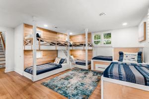 two bunk beds in a room with wooden walls at Lakefront Living w/Optional Boat Rental in Mooresville