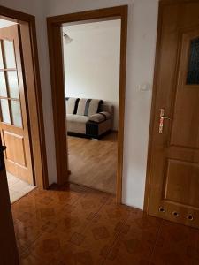 a living room with a couch and a door at Nassiena in Mierzyn