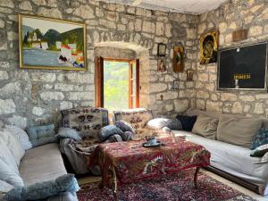 a living room with a stone wall at Artist's House on the Mountain in Zelenika
