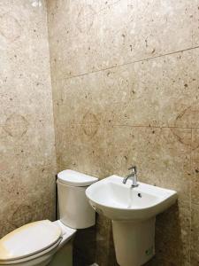 a bathroom with a toilet and a sink at Caliah Homes in Balamban +15 photos