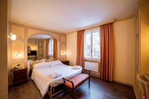 a bedroom with a bed and a large window at Phi Hotel Canalgrande in Modena +152 photos