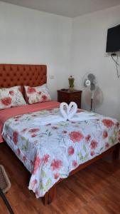 a bedroom with a bed with a bow on it at Casa San Martin Tarapoto in Tarapoto