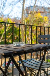 a wooden table and two chairs on a balcony at Abba Rambla Hotel in Barcelona