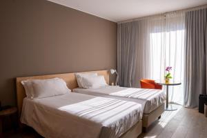 Rúm í herbergi á Parc Hotel Billia