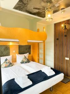 a bedroom with a bunk bed with white sheets at Villa Fantasia Budget Boutique Hotel in Füssen