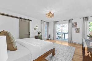 a white bedroom with a bed and a table at Niblick on Norman w/Heated Pool & Optional Boat Rental in Cornelius +41 photos