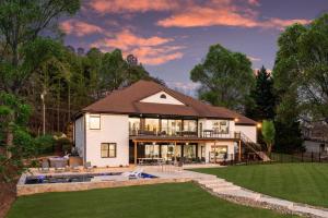 a large white house with a pool in the yard at Salience Path w/Heated Pool & Game Room in Mooresville