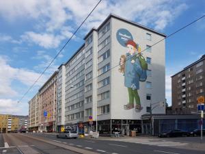 a building with a painting of a woman on it at SweetDream Guesthouse in Helsinki