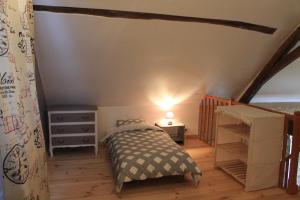 a small bedroom with a bed and a dresser at Gîte de La Huaudière in Mosnes