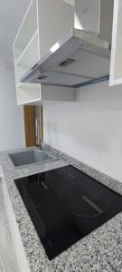 a kitchen with a sink and a stove at Holidays Domus Papokkio in Igualada