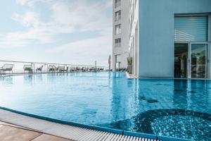 a swimming pool on the roof of a building at Dan Tel Aviv Hotel in Tel Aviv